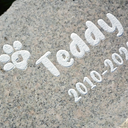 Tiergrabstein Granit mit Pfote und Name. Lebensdaten als weiße Gravur