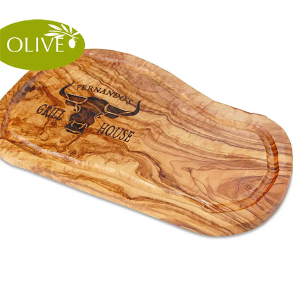 Motiv GRILL HOUSE mit Wunschnamen und stilisiertem Rinderkopf von vorne - Mediterranes Schneidebrett aus Olivenholz mit Saftrille und personalisierten Gravurmotiv - Jeske Design